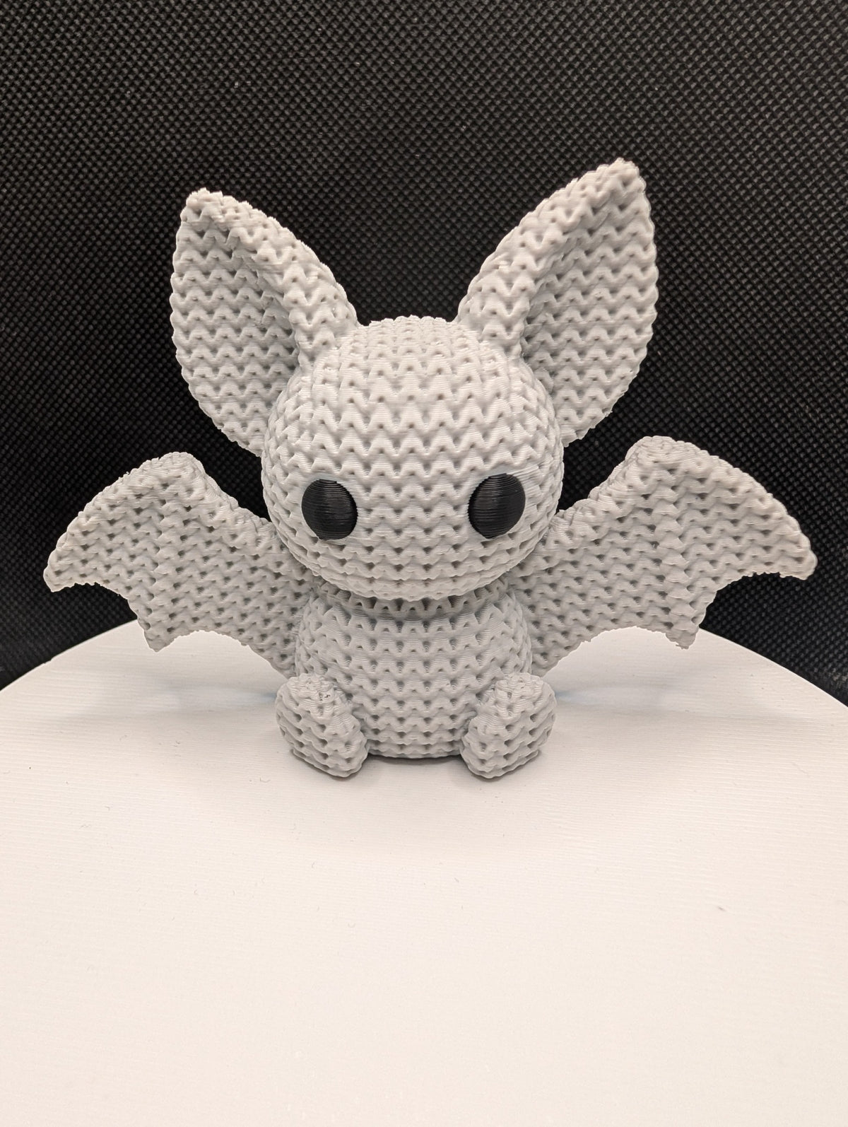Knitted-style 3D-printed bat figurine with oversized ears and outstretched wings