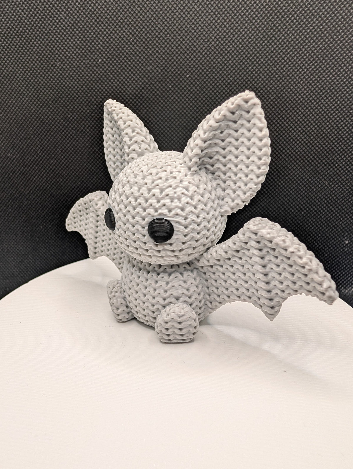 Knitted-style 3D-printed bat figurine with oversized ears and outstretched wings