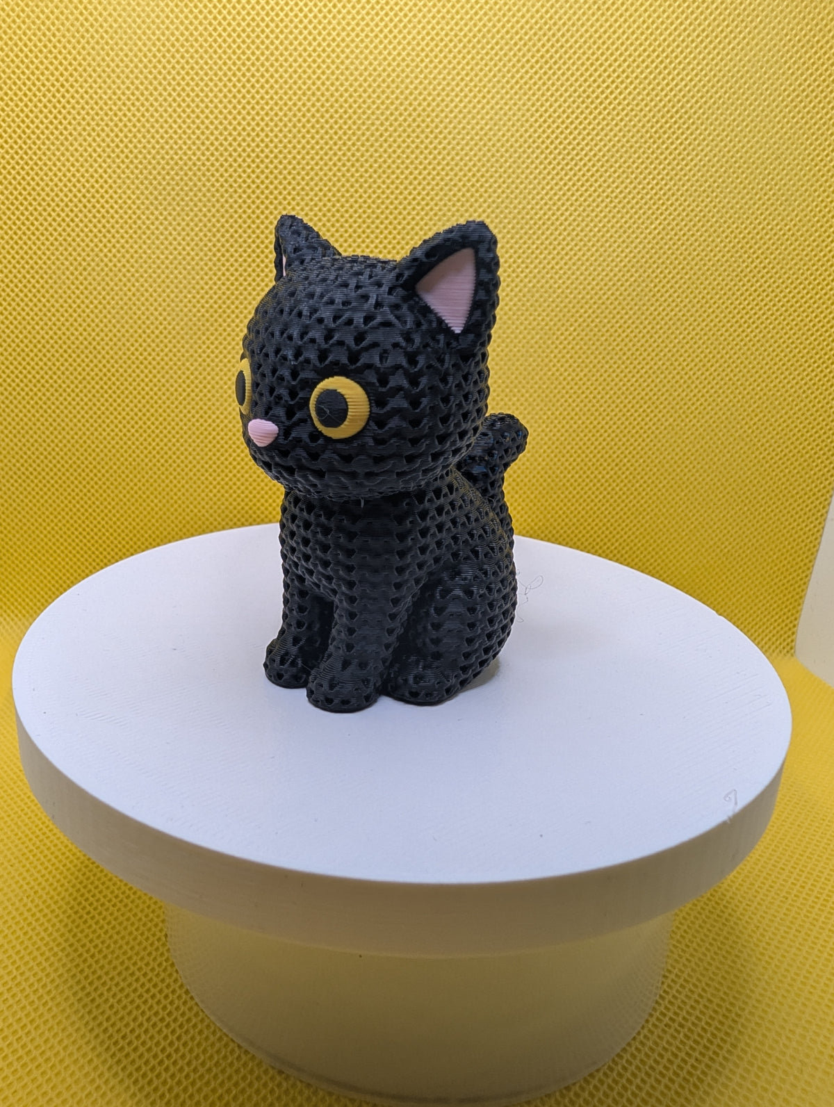 Angled view of knitted-style black cat figurine