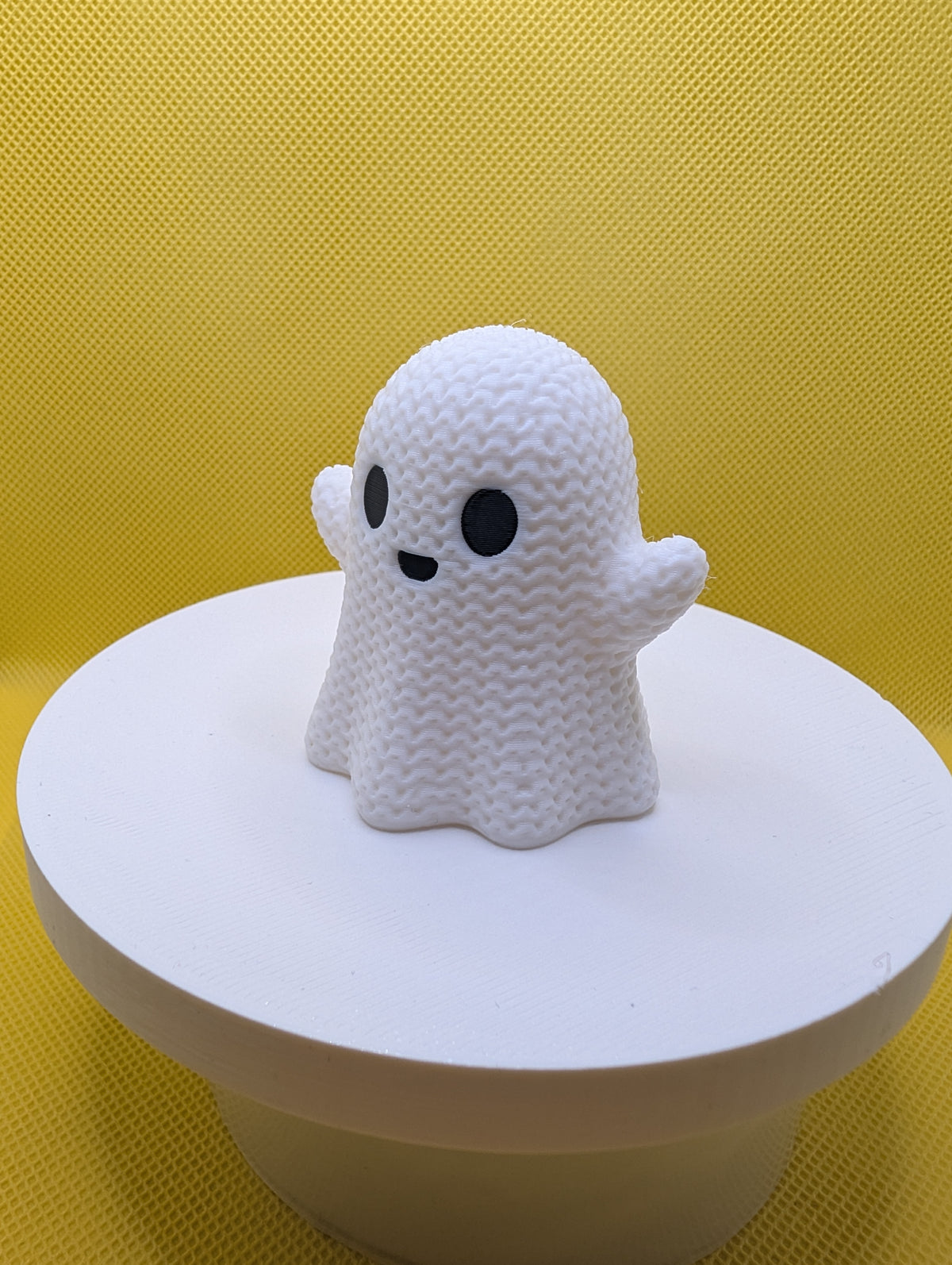 Angled view of white smiling ghost ornament