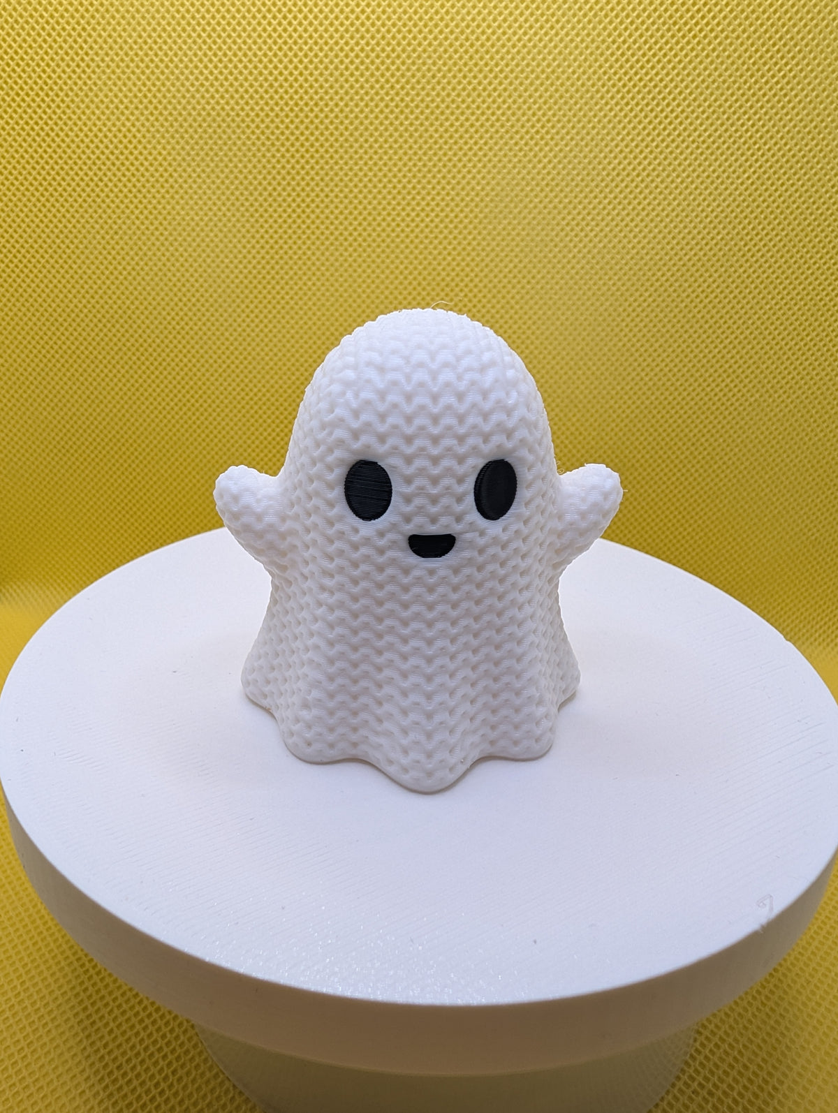 Front view of white smiling ghost with knitted-style texture